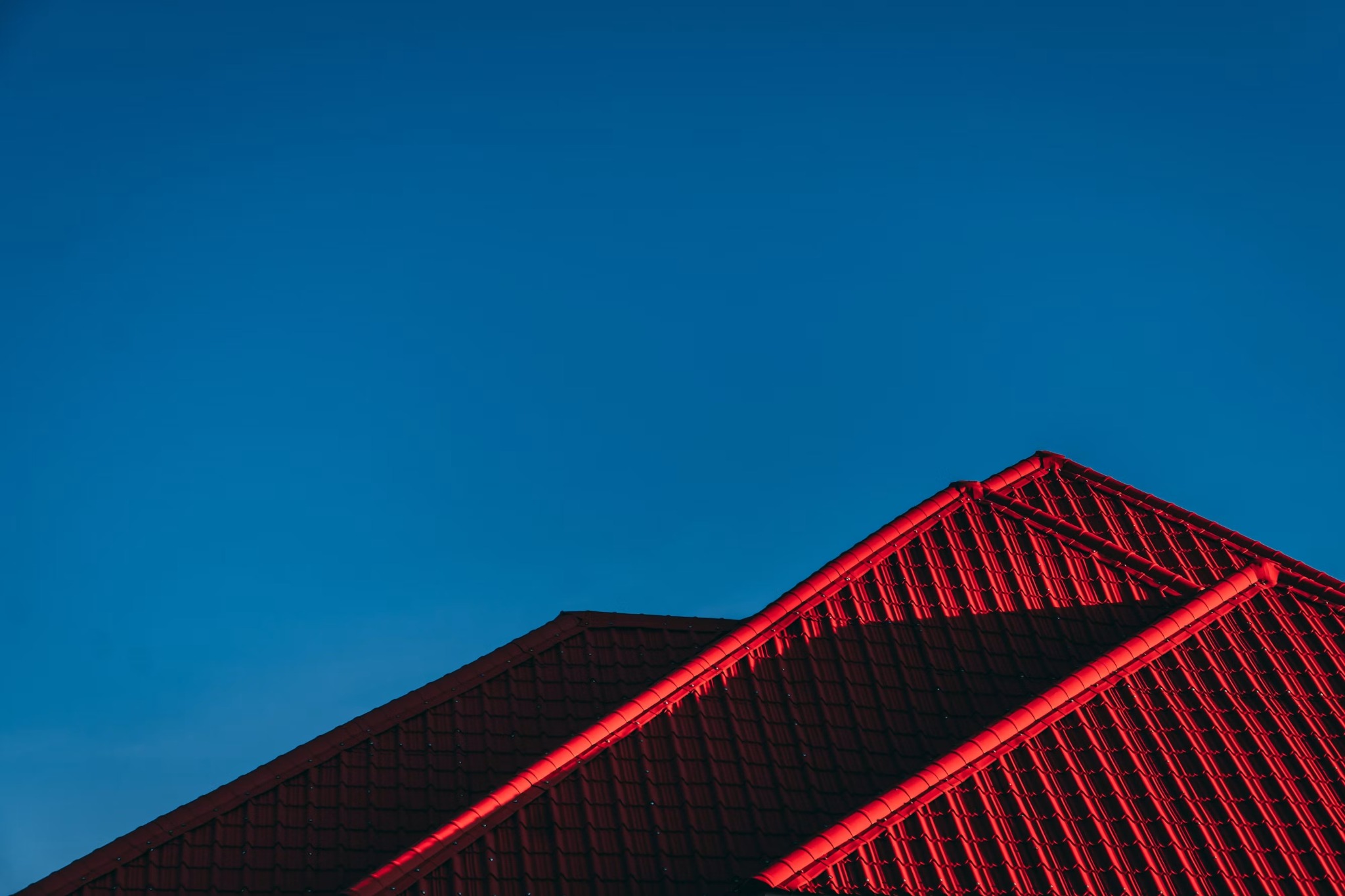 Red tile roof against a clear blue sky